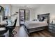 Comfortable bedroom with dark wood accents, desk, and balcony access at , Las Vegas, NV 89135