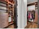 Walk-in closet with custom wood shelving for shoes and folded garments and hanging clothes at , Las Vegas, NV 89135