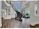 Open foyer with curved staircase, wood floors, and large windows offering plenty of natural light at , Las Vegas, NV 89135