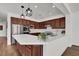 Well-equipped kitchen featuring stainless steel appliances, sleek countertops, dark wood cabinets and stylish pendant lighting at , Las Vegas, NV 89135