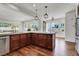 Bright open kitchen showcasing an island with white countertops, dark wood cabinets, and an adjacent living area at , Las Vegas, NV 89135