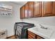 Efficient laundry room with washer, dryer, sink, and upper cabinets at , Las Vegas, NV 89135