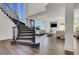 Sun-filled living room and staircase with modern furnishings and dark wood flooring at , Las Vegas, NV 89135