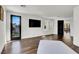 Well-lit living room with hardwood floors, a black TV and a door to an outdoor patio at , Las Vegas, NV 89135
