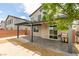 A modern-landscaped backyard includes a covered patio, grilling station, and view of the home's attractive exterior at 1004 Huckburn Ave, Henderson, NV 89015