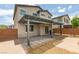 A stylish backyard with a covered patio extends from the home, providing an ideal space for relaxation and entertainment at 1004 Huckburn Ave, Henderson, NV 89015