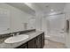 This bathroom features a granite countertop, tiled floor, and shower/tub combo at 1004 Huckburn Ave, Henderson, NV 89015