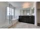 Bathroom features a granite countertop with dual sinks, and a shower/tub combo at 1004 Huckburn Ave, Henderson, NV 89015