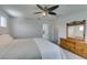 Bedroom features neutral walls, carpet, ceiling fan, Queen bed and wooden dresser with mirror at 1004 Huckburn Ave, Henderson, NV 89015
