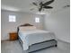 Bedroom with neutral walls, carpet, a ceiling fan, a Queen sized bed and two windows at 1004 Huckburn Ave, Henderson, NV 89015