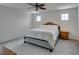 The bedroom features neutral walls, carpet, a ceiling fan, and a Queen sized bed at 1004 Huckburn Ave, Henderson, NV 89015