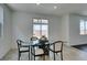 Dining area features a glass table and modern chairs, complemented by a sliding door to the backyard at 1004 Huckburn Ave, Henderson, NV 89015
