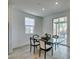 Bright dining area featuring a glass table, modern chairs, and sliding glass doors to the patio at 1004 Huckburn Ave, Henderson, NV 89015