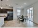 Dining area with modern table, access to backyard, connecting kitchen with stainless steel refrigerator at 1004 Huckburn Ave, Henderson, NV 89015