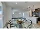 Dining space connects to living area, featuring modern table set, and sliding doors to outdoor patio at 1004 Huckburn Ave, Henderson, NV 89015