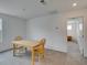 Bright dining room with neutral carpet, natural light, and simple furnishings at 1004 Huckburn Ave, Henderson, NV 89015