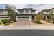 Charming two-story home featuring a gray color scheme, complemented by a well-manicured lawn and a two-car garage at 1004 Huckburn Ave, Henderson, NV 89015