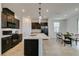 Contemporary kitchen with island, stainless appliances, and adjacent dining area at 1004 Huckburn Ave, Henderson, NV 89015