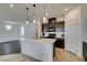 Modern kitchen features a large island with pendant lighting and dark wood cabinets at 1004 Huckburn Ave, Henderson, NV 89015