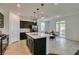 Well-lit kitchen features a central island, dark cabinets, and dining area with sliding glass doors at 1004 Huckburn Ave, Henderson, NV 89015