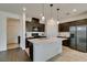 Open kitchen design featuring a large island, dark wood cabinets, and stainless steel appliances at 1004 Huckburn Ave, Henderson, NV 89015