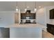 Bright kitchen showcases a spacious island with modern pendant lights and stainless steel sink at 1004 Huckburn Ave, Henderson, NV 89015
