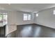 Bright living room featuring hardwood floors and sliding door leading to a backyard patio at 1004 Huckburn Ave, Henderson, NV 89015