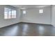 Bright living room featuring hardwood floors and large windows, offering abundant natural light at 1004 Huckburn Ave, Henderson, NV 89015