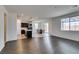 Open concept living room featuring hardwood floors, a connected kitchen, and abundant natural light at 1004 Huckburn Ave, Henderson, NV 89015