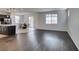 Open concept living room featuring hardwood floors, a connected kitchen, and abundant natural light at 1004 Huckburn Ave, Henderson, NV 89015