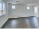Bright living room featuring hardwood floors and large windows, offering abundant natural light at 1004 Huckburn Ave, Henderson, NV 89015