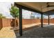 Covered patio featuring a brick wall and a landscaped area with gravel at 1004 Huckburn Ave, Henderson, NV 89015