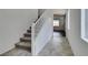 Bright staircase with carpeted steps and white railing, leading to the upper level of the home at 1004 Huckburn Ave, Henderson, NV 89015