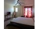 Bedroom with neutral walls and red curtains, a ceiling fan, and carpeted floor at 10360 Lettuce Leaf St, Las Vegas, NV 89183