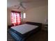 Bedroom with neutral walls and red curtains, a ceiling fan, and carpeted floor at 10360 Lettuce Leaf St, Las Vegas, NV 89183