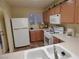 Well-lit kitchen with a white refrigerator and modern gas range at 10360 Lettuce Leaf St, Las Vegas, NV 89183