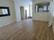 Spacious living room with wood floors and ample natural light from a window at 10360 Lettuce Leaf St, Las Vegas, NV 89183