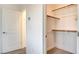 Walk-in closet with wooden racks, neutral carpet and white walls, providing ample storage space at 1157 Blossom Point St, Las Vegas, NV 89135