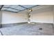Spacious garage with concrete flooring, bright lighting, and door to interior, ready for customization at 1157 Blossom Point St, Las Vegas, NV 89135