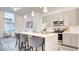 Bright kitchen with a quartz countertop island, stainless steel appliances and gray cabinets at 1157 Blossom Point St, Las Vegas, NV 89135