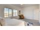 Bright main bedroom with a reading chair, large windows, and a neutral color palette at 1157 Blossom Point St, Las Vegas, NV 89135