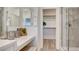 A luxurious bathroom features a glass-enclosed shower and a walk-in closet with wooden shelves at 1163 Blossom Point St, Las Vegas, NV 89135