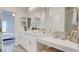 A modern bathroom features a double sink vanity, makeup vanity, and an open view to the bedroom at 1163 Blossom Point St, Las Vegas, NV 89135