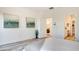 Well-lit bedroom leading to the laundry room and bathroom; features modern decor and ample space at 1163 Blossom Point St, Las Vegas, NV 89135