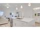 Open kitchen and living area with large island, modern finishes, and access to the bathroom at 1163 Blossom Point St, Las Vegas, NV 89135
