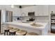 Modern kitchen featuring stainless steel appliances, sleek white cabinets, and a convenient center island with barstools at 1164 Prospering Creek St, Las Vegas, NV 89135