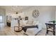 Open living area featuring modern decor, a plush sofa, and a stylish kitchen with stainless steel appliances at 1164 Prospering Creek St, Las Vegas, NV 89135