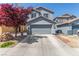 Two-story home featuring a two-car garage and a drought-tolerant landscaped front yard at 11739 Village Arbor St, Las Vegas, NV 89183