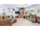 Spacious living room with a comfortable sofa, television, and plants at 11739 Village Arbor St, Las Vegas, NV 89183