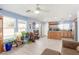 An open-plan living room and kitchen, with blue walls, neutral wood floors, and stainless steel appliances at 11739 Village Arbor St, Las Vegas, NV 89183